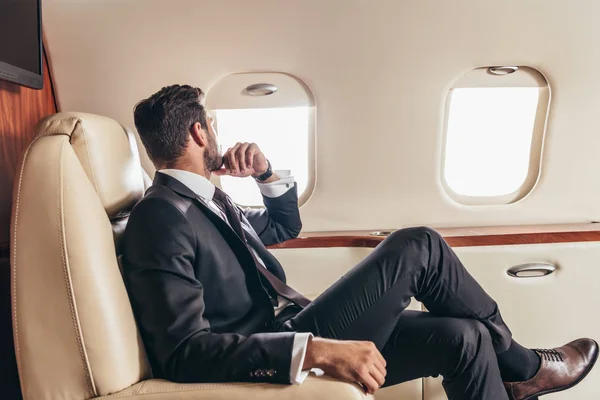 depositphotos_312320396-stock-photo-back-view-businessman-suit-looking
